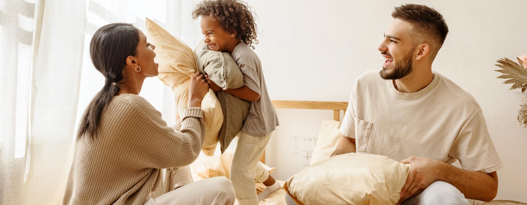 a family sitting on a bed