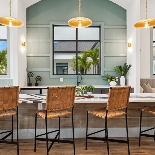 a commuity kitchen with a large table seating and windows
