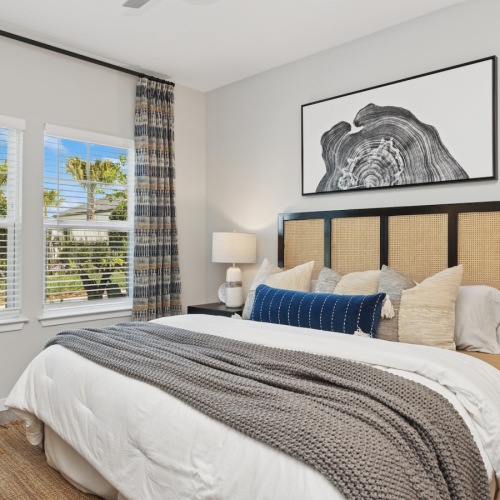 bedroom with bed lamps art and window