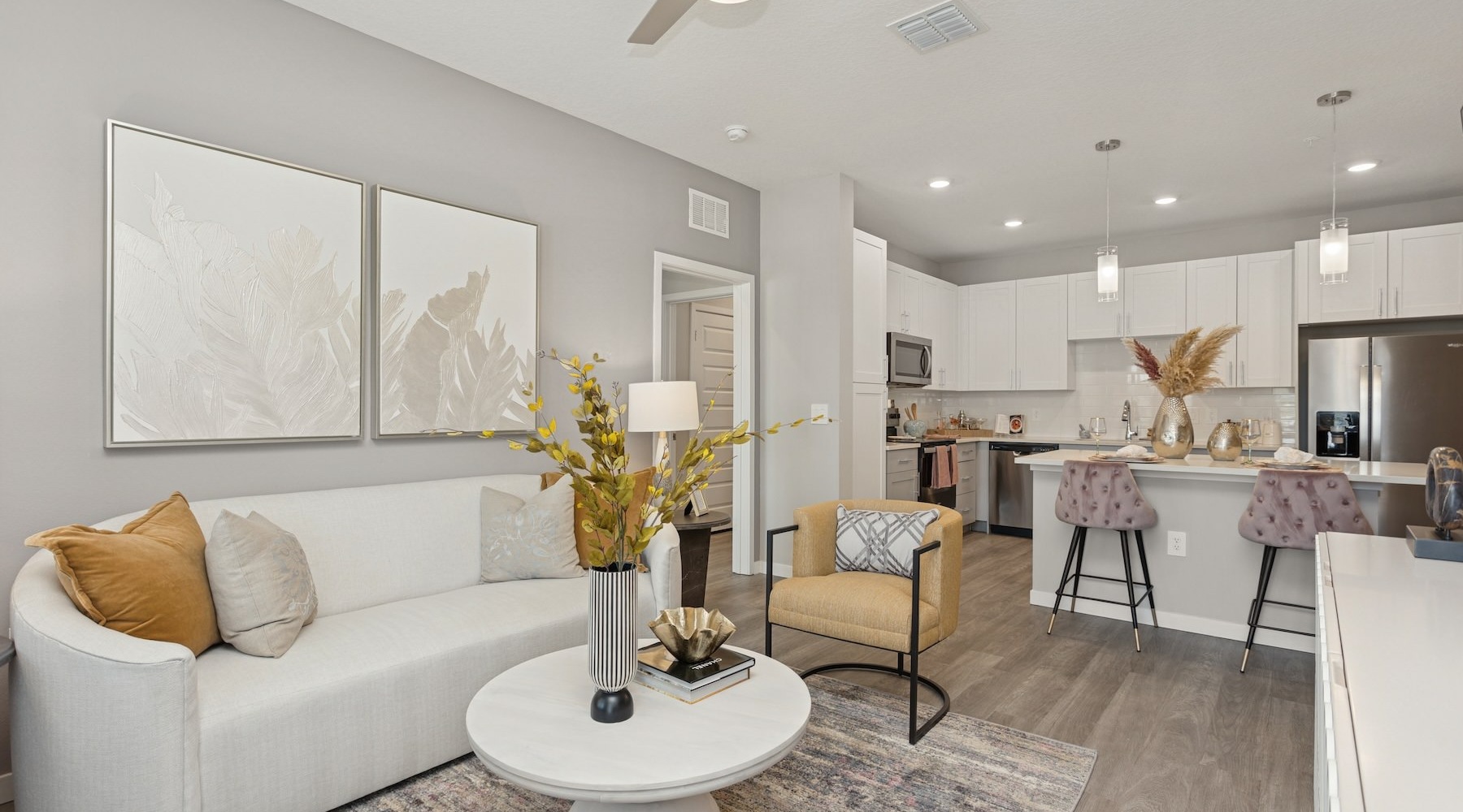 living room with furniture and a view of a kitchen